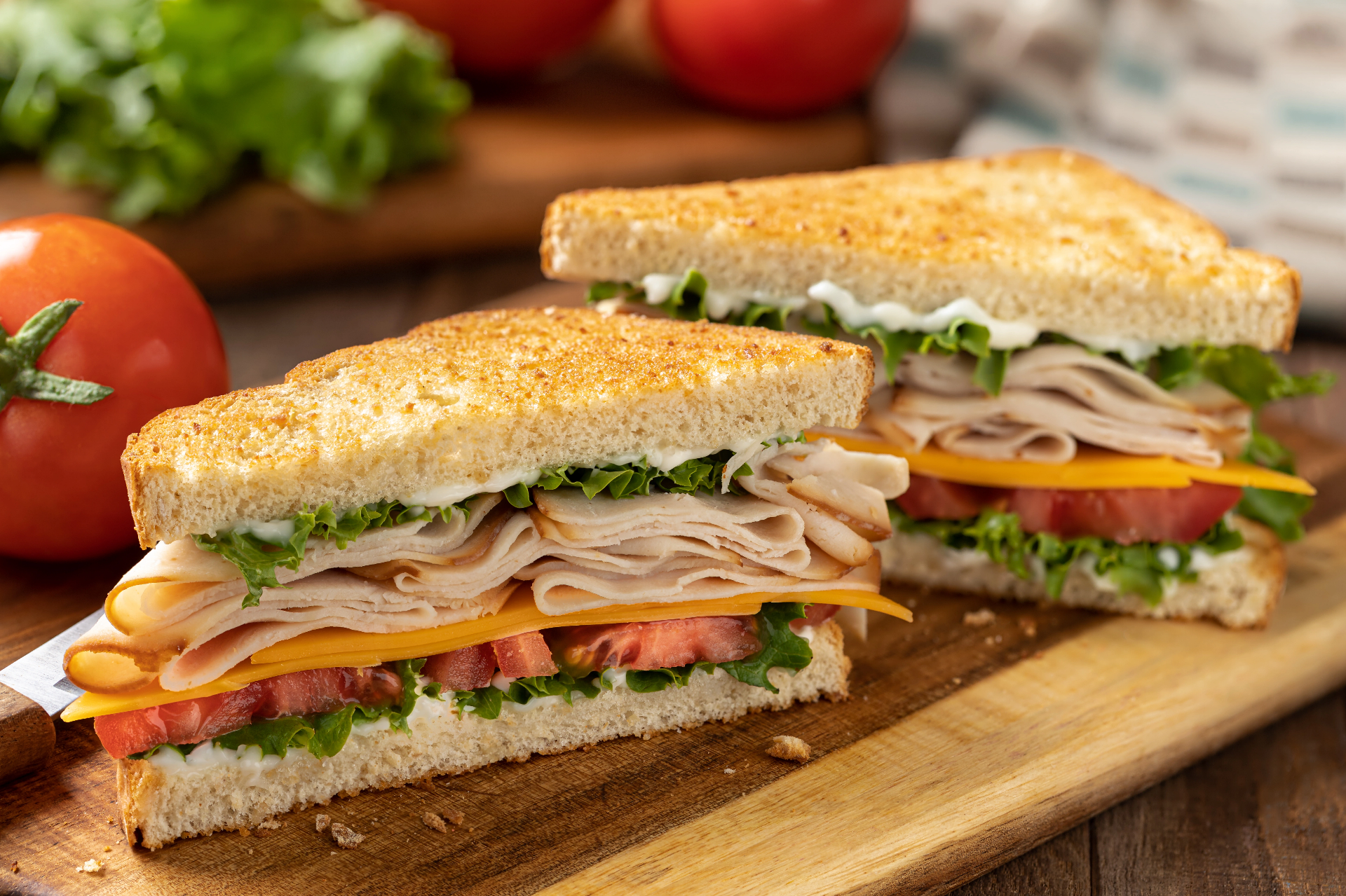 Fresh deli sandwiches with turkey, cheese, lettuce, and tomato