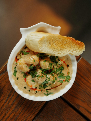 A bowl of soup with toasted bread