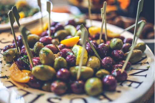 Assorted Mediterranean-style olives and garnishes served as a small plate highlighting global flavors