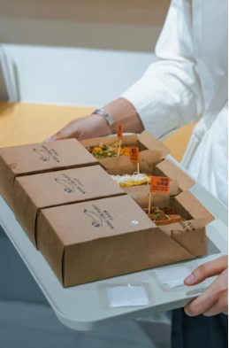 This image shows Neatly prepared takeaway boxes presented for delivery