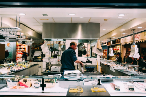 Chef preparing fresh seafood on a counter with lemon, herbs, and kitchen tools ready for cooking